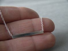 "I have to admit this: I have a thing for minimal jewelry. This feminine geometric necklace has a square bar sets horizontally on a sterling silver chain. The rod sits naturally on your neck, and add a touch of elegance to your outfit. Sleek and understated but with a distinctive wow factor! Measures/Details Bar measures 1.2\" (3cm) Please select the length you prefer at check-out. You can have 14\", 16\", 18\", 20\", however if you want a different length, please send me a message. All my piece Bar Sets, Square Bar, Silver Bar Necklace, Silver Bar, Minimal Jewelry, Geometric Necklace, Silver Bars, Silver Pieces, Bar Necklace