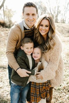 a man and woman with two children posing for a family photo