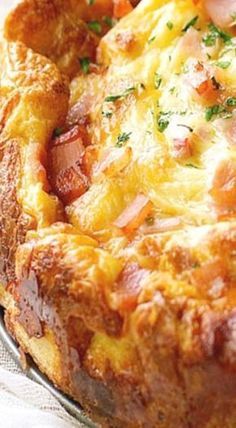 a cheesy bread dish with ham and cheese on the top is ready to be eaten