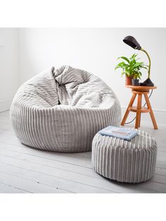 a bean bag chair and foot stool in a room