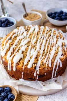 a cake with icing and blueberries on top