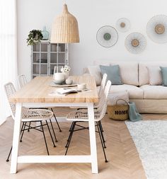 a living room filled with furniture and a wooden table in front of a white couch