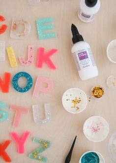 the letters are made out of plastic and have glitter on them, such as paint