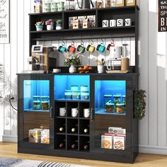 a black and blue display case filled with lots of food on top of a wooden floor