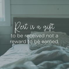 a bed with a comforter on it and a quote about rest in a gift to be received not a reward to be earn