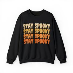 "Embrace the spook-tacular season with our bewitching \"Stay Spooky\" Halloween sweater, featuring the hauntingly fun phrase in eerie fonts!  🍂 Fall Sweatshirt | 🎃 Halloween Sweatshirt | 😊 Cute Halloween Sweater | 😂 Funny Fall Sweater | 🎃 Halloween Sweater | 🍁 Fall Gear 👻 Charming \"Stay Spooky\" Design: This delightful Halloween sweater showcases the fun and eerie phrase \"Stay Spooky\" in spooky fonts, adding a touch of enchantment to your fall wardrobe. 🍁 Cozy & Comfortable: Made with premium materials, our sweater ensures a soft and comfortable fit for all-day wear during your Halloween adventures. 🎃 Versatile & Spook-tastic: Ideal for Halloween events or casual wear, our sweater effortlessly combines style with spooky fun. Embrace the magic of the season in this charming piec Spooky Black T-shirt For Winter, Spooky Black Halloween Sweatshirt, Spooky Black Sweatshirt With Graphic Print, Spooky Graphic Print Sweatshirt For Streetwear, Black Horror-themed Sweatshirt For Fall, Black Horror Sweatshirt For Fall, Horror Long Sleeve T-shirt With Letter Print, Long Sleeve Horror T-shirt With Letter Print, Horror Style Long Sleeve T-shirt With Letter Print