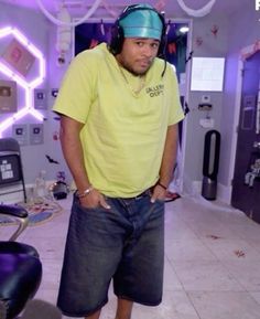 a man standing in a room with headphones on