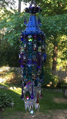 a blue wind chime hanging from a tree