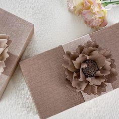 two boxes with flowers on them sitting next to each other