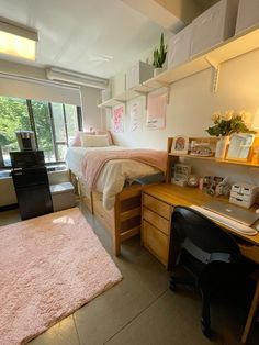 a bedroom with a bed, desk and window