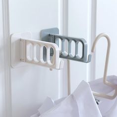 the door handle is attached to an ironing board and has two hooks on it