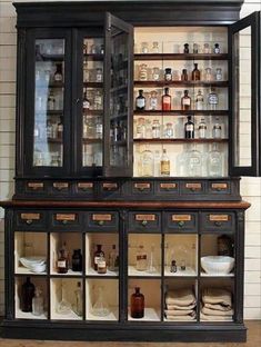 an old china cabinet with many bottles on it