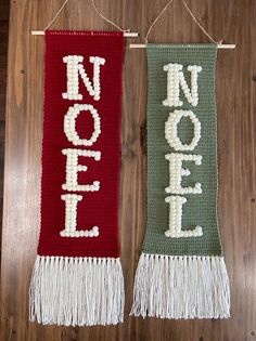 two knitted banners with the word noel hanging on a wooden wall next to each other