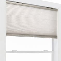 an open window with white blinds on it