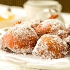 powdered sugar covered pastries on a white plate