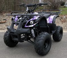 a purple and black atv is parked on the street