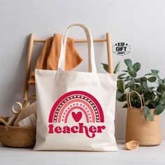 a white tote bag sitting on top of a wooden chair next to a potted plant