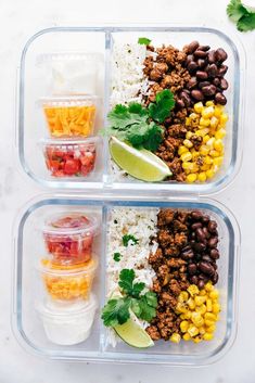 two plastic containers filled with rice, beans and other foods next to lime wedges