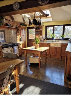 a large kitchen with wooden cabinets and an island in the middle, along with potted plants