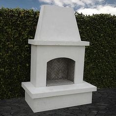 an outdoor fireplace is shown in front of a hedge