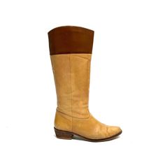 Vintage 1970s women's tan leather knee high western style riding boots. Features tan leather uppers with brown leather band at top of shaft, rounded toe, pull on style with no closures, rounded tops, and short wooden block heel. Very good vintage condition with wear at sides and toe. No branding stamp.   Heel to toe (inside shoe): 9.375 inches  Ball of foot (bottom of sole): 3.25 inches  Heel height: 1.5 inches  Shaft height: 13.5 inches  Circumference: 14 inches  Size 7 Brown Knee-high Boots For Ranch In Fall, Western Brown Leather Knee-high Boots, Western Style Brown Leather Knee-high Boots, Fitted Western Brown Knee-high Boots, Fitted Brown Knee-high Boots For Ranch, Western Brown Knee-high Boots With Round Toe, Vintage Brown Leather Knee-high Boots, Retro Leather Knee-high Boots With Round Toe, Brown Wide Calf Knee-high Boots With Leather Sole