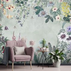 a living room with flowers painted on the wall and a chair in front of it