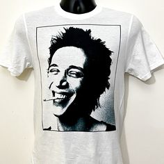 "Richard Hell T-shirt  -100% cotton -Professional print (not an iron-on) Sizes available: XS, S, M, L, XL, XXL Size Guide (width x length)* XS - 17\"(43cm) x 26\"(66cm) S - 18\"(46cm) x 28\"(71cm) M - 19\"(48cm) x 29\"(74cm) L - 21\"(53cm) x 30\"(76cm) XL - 23\"(58cm) x 31\"(79cm) XXL - 25\"(63cm) x 32\"(81cm) * Measured with shirt laying flat. PROCESSING/DELIVERY TIMES: Ships in 3-4 business days. Delivery times as follows: -- US/Domestic: 5 to 10 Business Days -- Canada/UK/International: 2 to 4 Weeks." Richard Hell, White Graphic Rock And Roll T-shirt, Tom Petty Shirt, 70s Punk, Rock T Shirt, Rock T Shirts, Quality T Shirts, Punk Rock, Print Quality