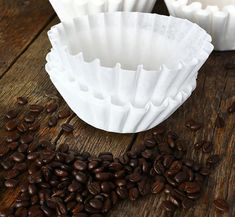 coffee beans and paper cups on a wooden table