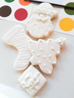 three decorated cookies sitting on top of a table next to a marker and some markers