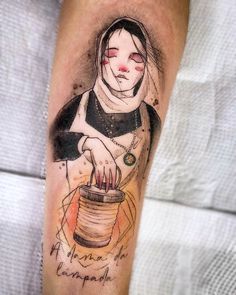 a person with a tattoo on their arm holding a jar and looking at the camera