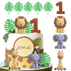 a birthday cake decorated with jungle animals and the number one