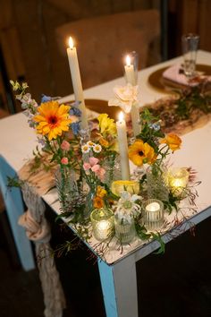 a table with candles and flowers on it