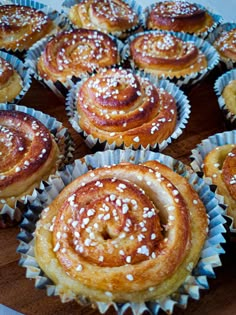 many pastries are sitting on a wooden platter