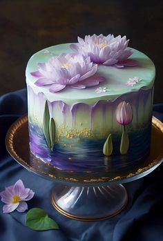 there is a cake decorated with flowers on the plate and water lilies around it