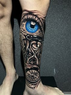 a man's leg with an eye on it and a clock in the middle