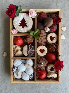 a box filled with lots of different types of cookies and pastries on top of a table