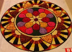 a colorful rug with hearts on it in the middle of a floor mat that has been made out of flowers