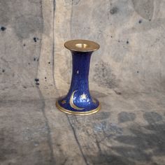 a small blue vase sitting on top of a table