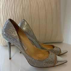 Women's Jimmy Choo Glittered Woven Pumps - Metallic Pumps Woven Glittered Pointed Toe Slip On Leather Sole Made In Italy. 100% Leather. Silver Heel. *Dust Bag Not Included. 100% Authentic. Condition: Gently Loved - Light Creasing And Wear Throughout Insoles. . Please Note: Jimmy Choo Shoes Typically Run 1 To 1 1/2 Sizes Smaller. All Sizing Is Dependent Of Shoe Style. Material: Lame, Metallic Leather Origin: Italy Hardware: Silver Plated Toe: Closed Heel Style: Stiletto Shoe Width: Regular Designer Sparkling Heels With Pointed Toe, Luxury Glitter Heels With Round Toe, Designer Sparkling High Heels, Silver Heel, Metallic Pumps, Stiletto Shoes, Silver Heels, Jimmy Choo Shoes, Leather Silver