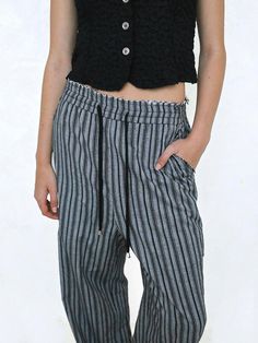 This is a trendy and feminine pants by Polysooem that is made out of high quality and sturdy material. With distinctive mood of the design and modern feminine look, you can style it for your casual daily outfit.- Relaxed wide silhouette- Elastic waistband and string and stopper on the hem- Feminine and trendy look Modern Wide Leg Trousers For Summer, Modern Wide-leg Pants For Summer, Modern Ankle-length Relaxed Fit Pants, Modern Black Ankle-length Pants, Chic Cotton Harem Pants For Work, Chic Cotton Harem Pants, Chic Cotton Ankle-length Harem Pants, Chic Ankle-length Cotton Harem Pants, Modern Ankle-length Spring Bottoms