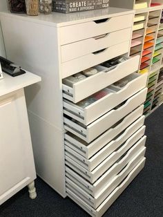 a white dresser with many drawers on top of it