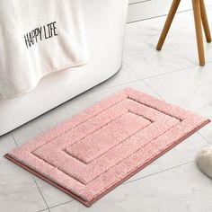 a bathroom rug that says happy life on it