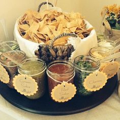 a platter filled with lots of different types of food and condiments on top of a table