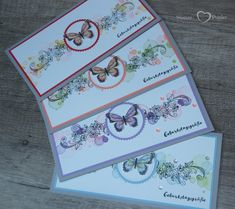 three cards with butterflies on them sitting next to each other