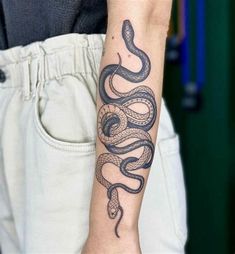 a person with a snake tattoo on their arm