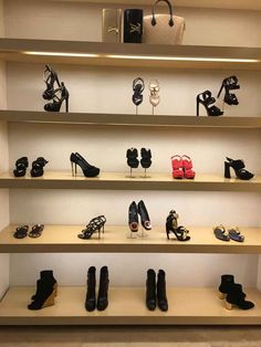 several shelves with shoes and purses on them