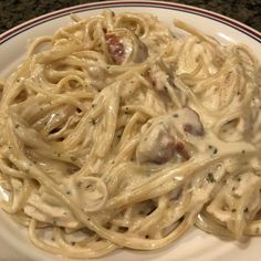 a white plate topped with pasta covered in sauce