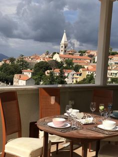 the table is set on the balcony overlooking the city