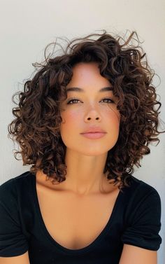 Go big and bold with a voluminous curly bob. This hairstyle is all about embracing your natural texture and showcasing your curls in their full glory. Curly Hairstyles Bob Natural Curls, A Line Curly Bob, Curly Haircut 2024, Curly Shag Bob, Short Curly Layered Hair, Long Bob Curly Hair, Short Naturally Curly Hair, Curly French Bob, Lob Curly Hair