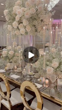 a table with white flowers and candles on it